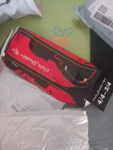 A shipping box crushed in transit labelled Violin Shoulder Rest 4/4-3/4, photographed by Elena V., a verified buyer